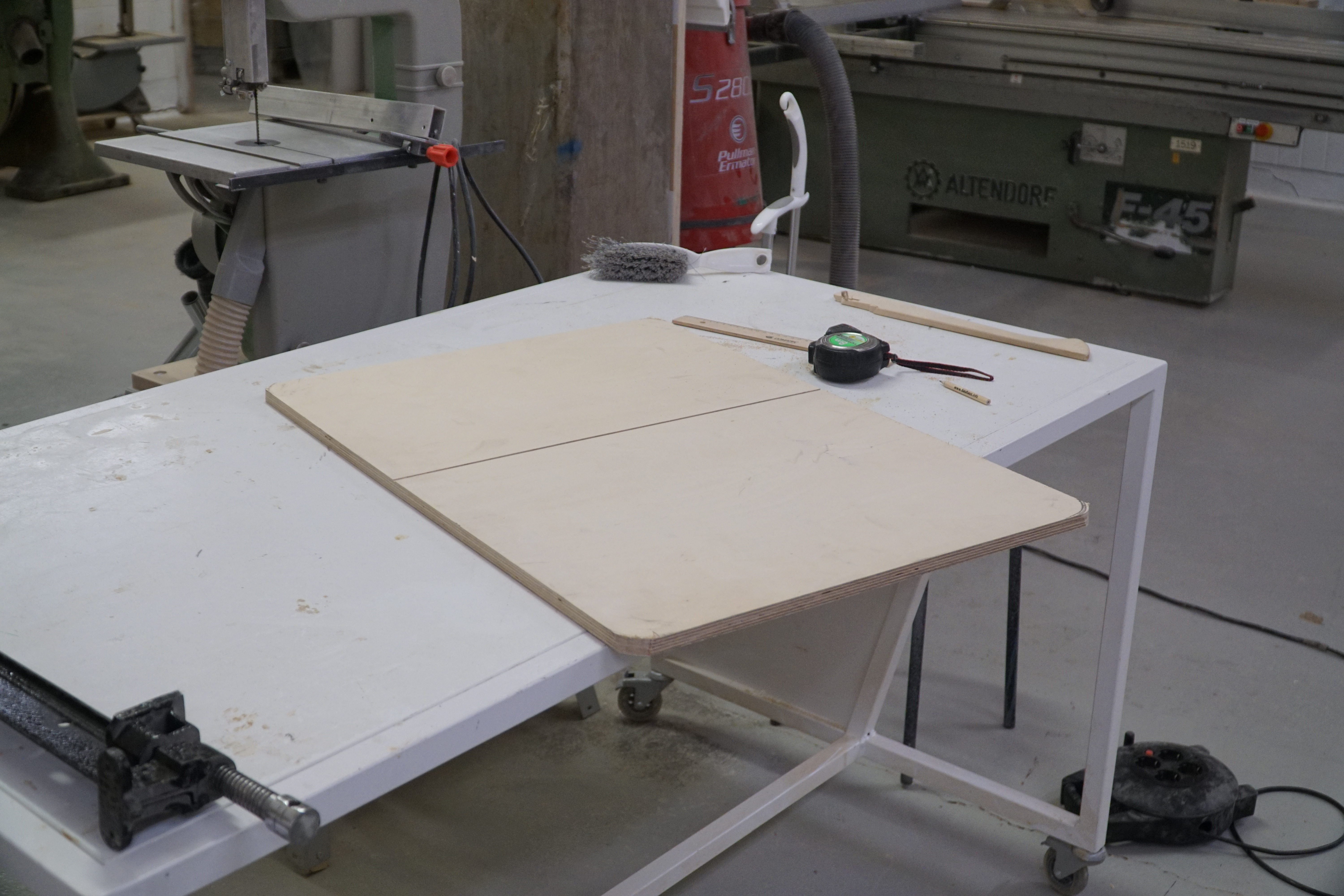 Cut the plank to size, preparing to round the corners with the belt sander